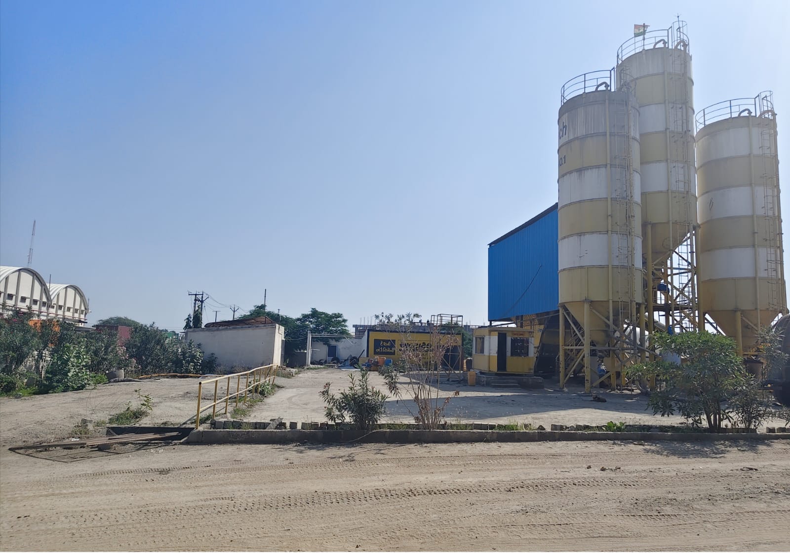 Batching plant yard beside industrial structures