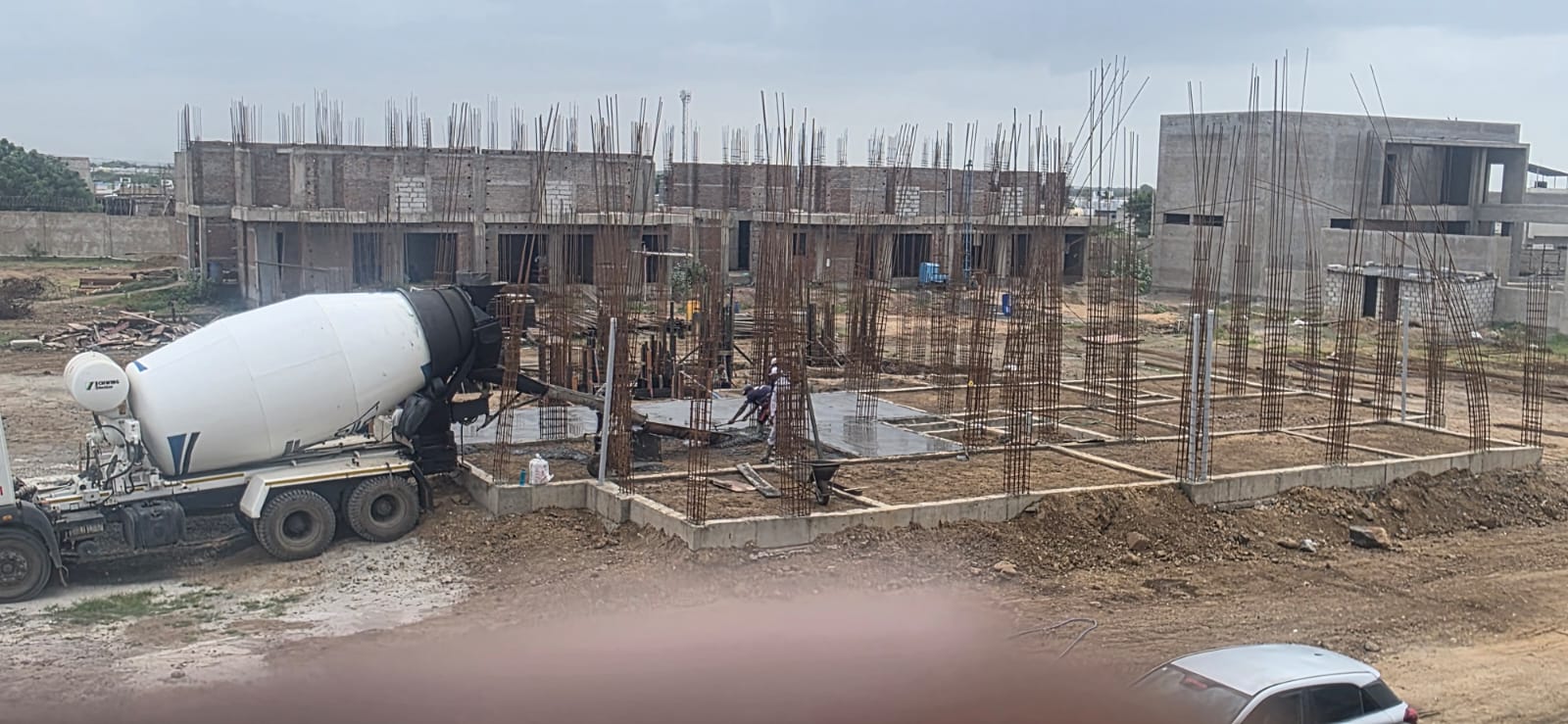Transit mixer beside a reinforced foundation during a concrete pour